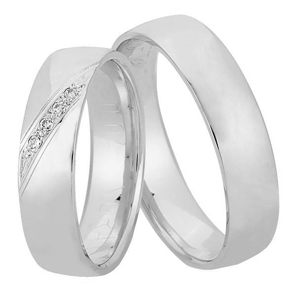 Eksklusive Nuran vielsesringe i 14 kt hvidguld med 4 diamanter i dameringen, 5 mm brede med afrundet profil.